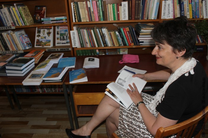 Ирина Аргутина изучает книги, изданные в Кизильском